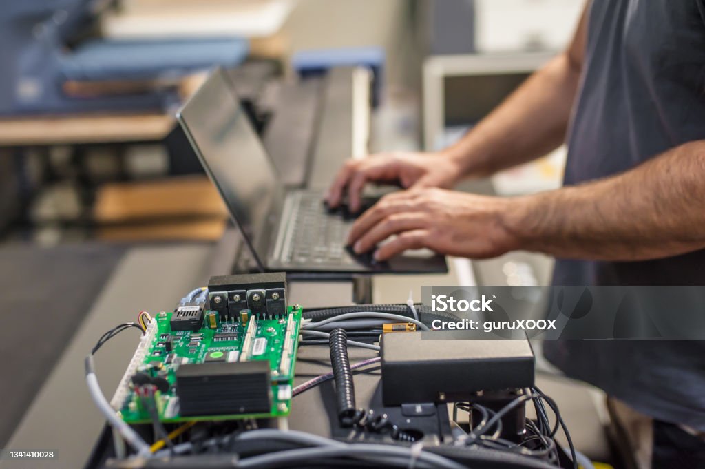 Engineer technician electrician inspect system with laptop computer. Electric installation Field service maintenance engineer technician electrician inspect and control machine hardware and software system with laptop computer. Electric installation Engineer Stock Photo