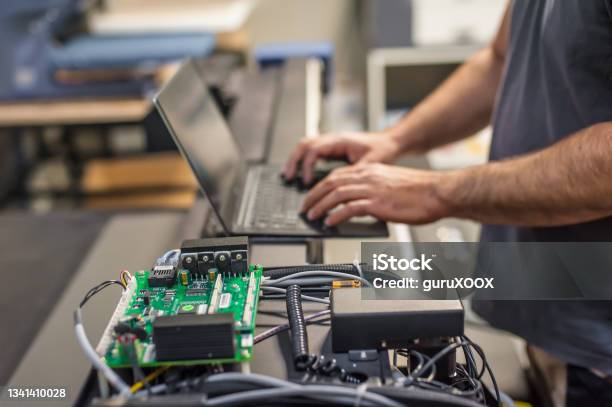 Engineer Technician Electrician Inspect System With Laptop Computer Electric Installation Stock Photo - Download Image Now