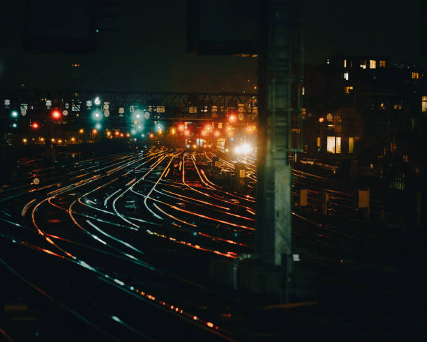 istock Curved railway tracks illuminated at night in the city 1341411390