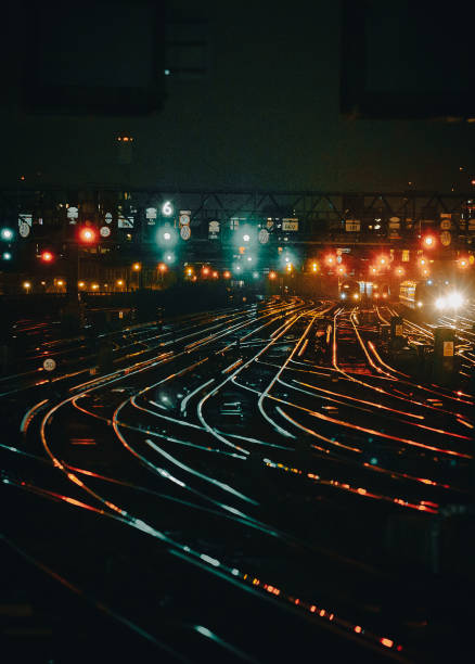 istock Curved railway tracks illuminated at night in the city 1341411391