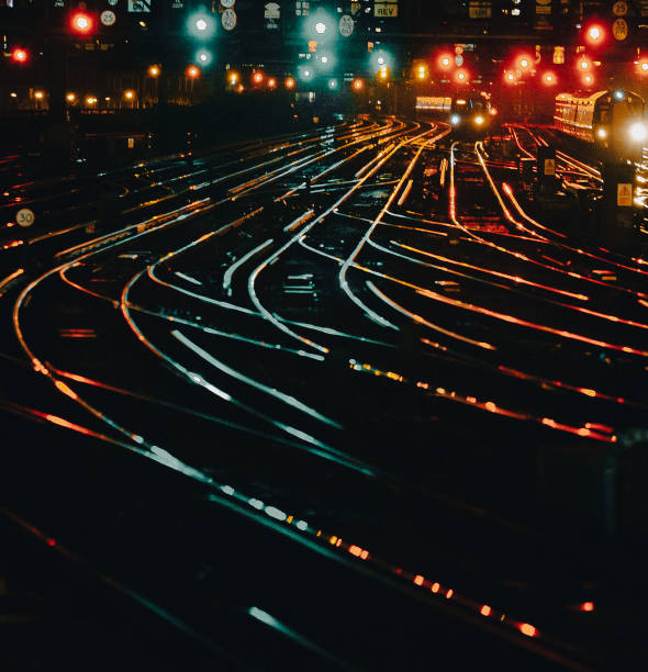 istock Curved railway tracks illuminated at night in the city 1341411392