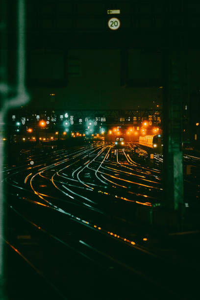 istock Curved railway tracks illuminated at night in the city 1341411393