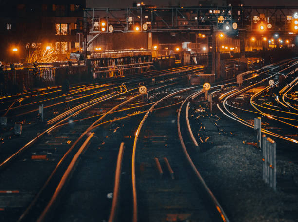 istock Curved railway tracks illuminated at night in the city 1341411402
