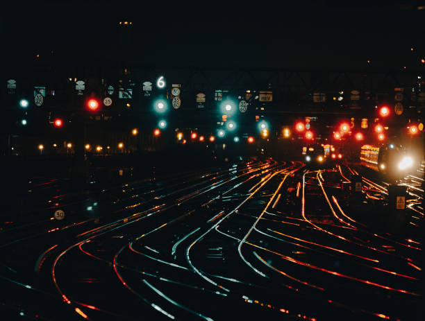 istock Curved railway tracks illuminated at night in the city 1341411404