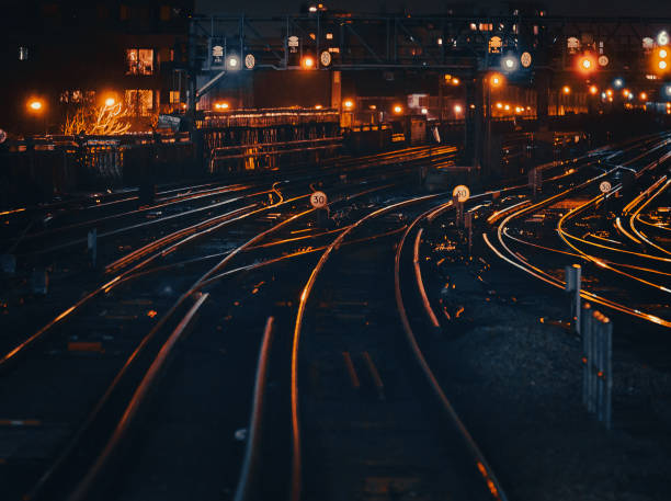 istock Curved railway tracks illuminated at night in the city 1341411405