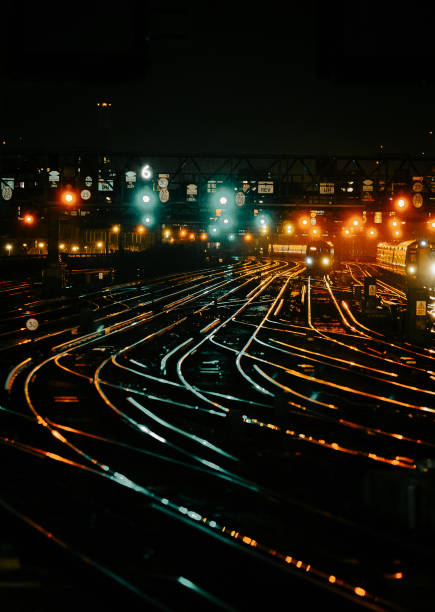 istock Curved railway tracks illuminated at night in the city 1341411406