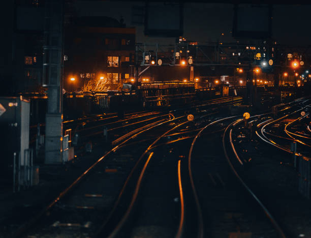 istock Curved railway tracks illuminated at night in the city 1341411410
