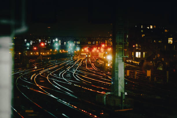 istock Curved railway tracks illuminated at night in the city 1341411411