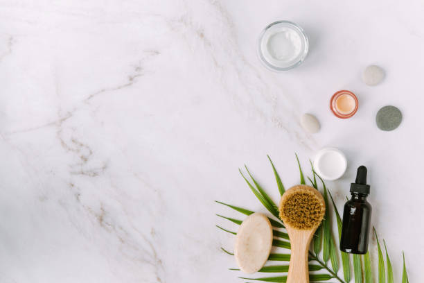 istock face brush and bottle with serum on palm tree leaf 1341412820