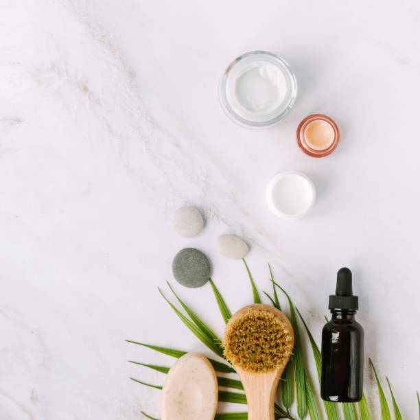 istock face brush and bottle with serum on palm tree leaf 1341412860