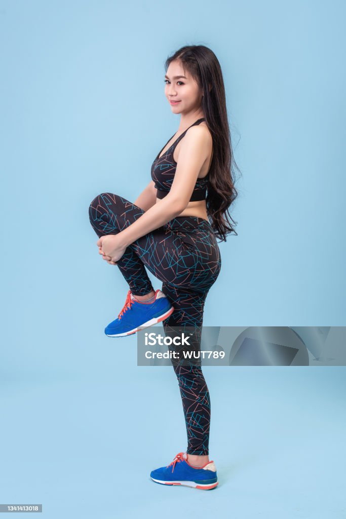 Young Asian Girls Wear Leggings To Exercise On A Pastel Blue Studio Scene  Stock Photo - Download Image Now - iStock