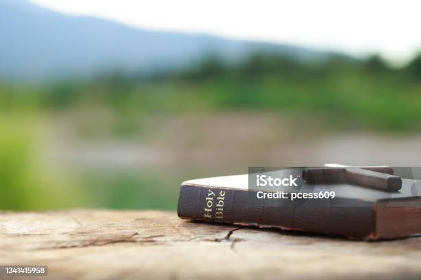A Wooden Cross On Holy Bible On Wooden Table Sunday Readings Bible Education Spirituality And Religion Concept Stock Photo - Download Image Now