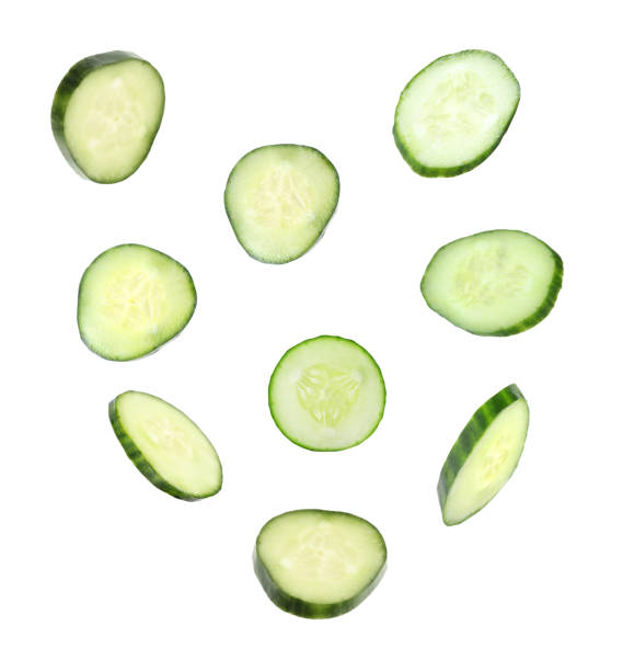 istock Set of flying fresh cucumber slices on white background 1341417391