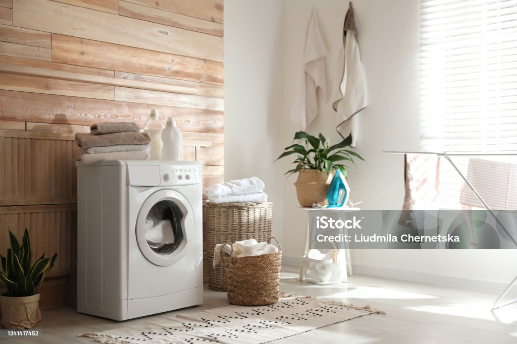 Stylish room interior with modern washing machine Washing Machine Stock Photo