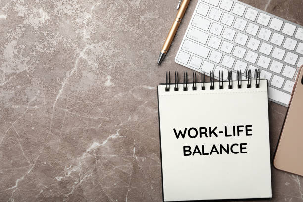 istock Work-life balance concept. Notebook and keyboard on grey marble table, flat lay 1341418749