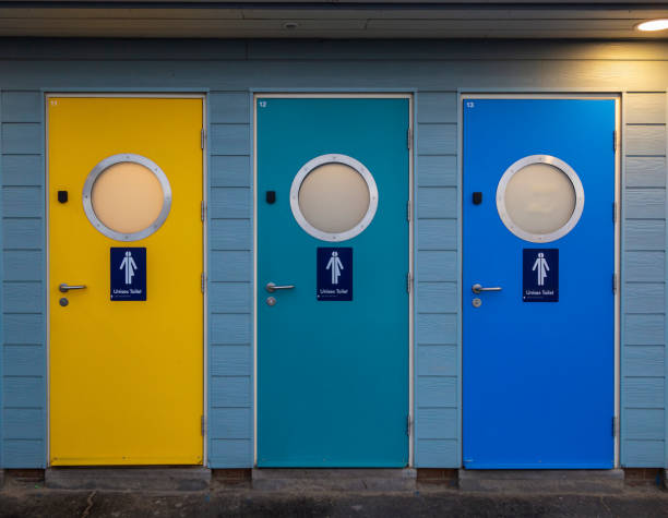 Unisex public toilet doors on the seafront at Weymouth in Dorset on the South Coast of England UK