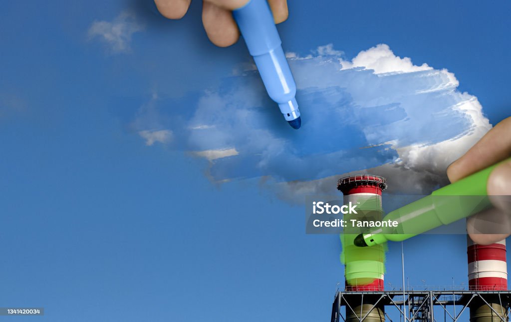 Hands painting blue and green pollution from a chimney hands painting pollution blue and polluting chimneys green. Greenwashing malpractice concept Greenwashing Stock Photo