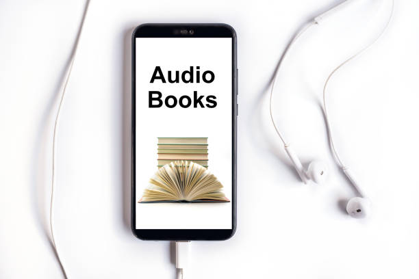 Smartphone with Audiobooks collection Smartphone with earphones and Audiobooks collection on screen audio book stock pictures, royalty-free photos & images