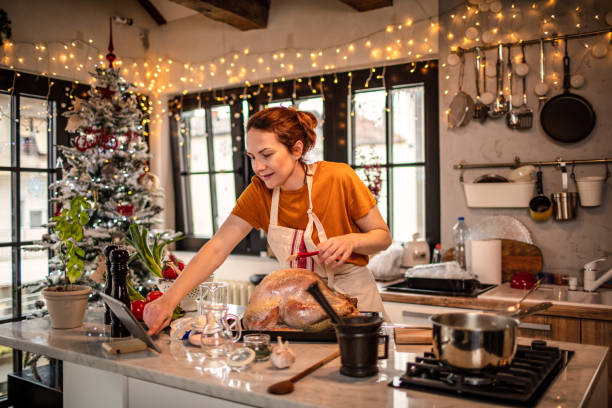 istock Young woman preparing a turkey for Christmas dinner 1341420508