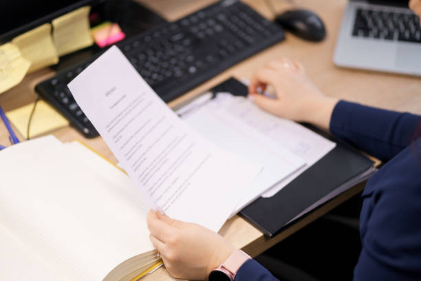 istock Woman working with papers in her office 1341421001