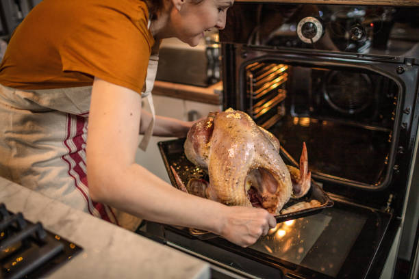 istock Cooking roast turkey in an oven 1341421089