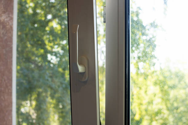 istock Slightly open window on background of wood and sunlight 1341421917