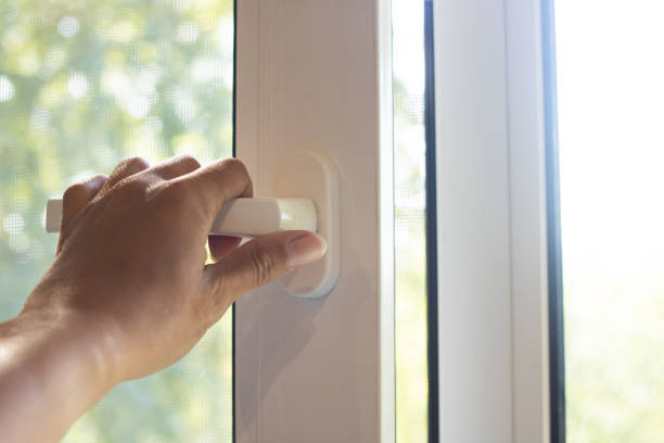 istock Slightly open window on background of wood and sunlight 1341421922
