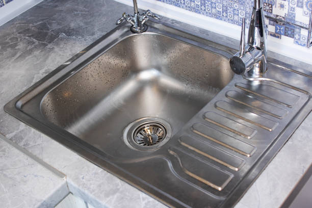 istock Metal kitchen sink and faucet close up 1341421968