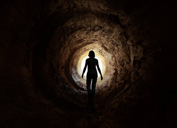 Walk into the light. Escape, exit, death Dark tunnel leading to the rotating light. May symbolise way to heaven after death, escape, exit, looking for freedom or clinical death vision. hypnosis circle stock pictures, royalty-free photos & images