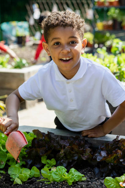 istock Helping In The School Garden 1341422439