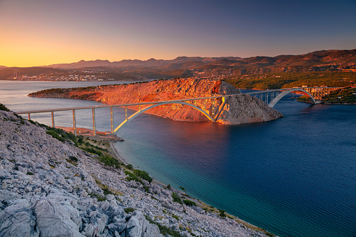 Image of Krk Bridge which connects the Croatian island of Krk with the mainland at beautiful summer sunset.