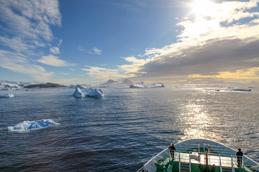 Expedition ship cruising past through icebergs, Trinity Peninsula, Antarctica.