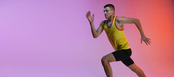 istock Young man, male athlete in motion isolated over gradient studio background. Running. Side view. Flyer 1341424588