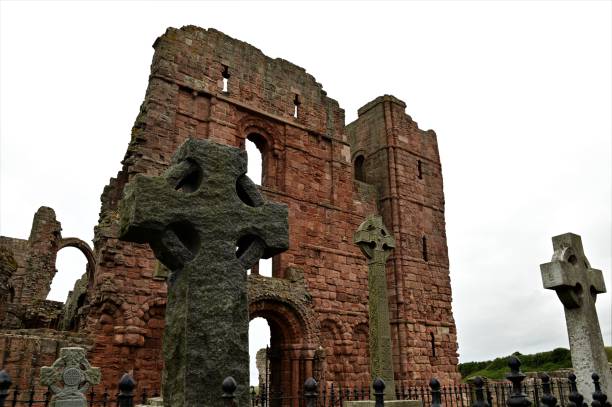 Landmarks of England - Lindisfarne An external view of the ruins of a medieval priory building on the island of Lindisfarne in Northumberland. lindisfarne monastery stock pictures, royalty-free photos & images