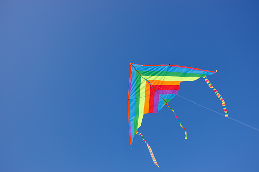 colorful kite flying in the clear blue sky