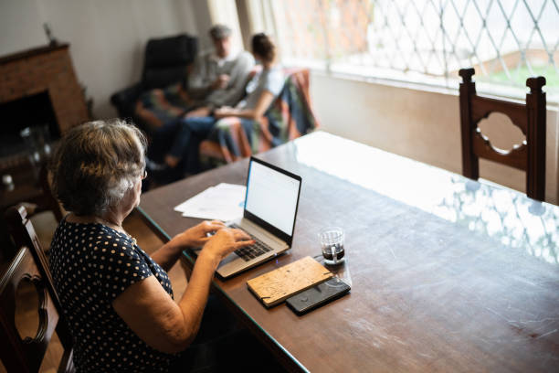 istock Senior woman using laptop at home 1341427672