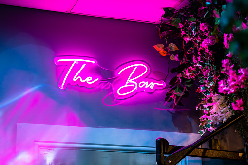 A pink neon light sign reading 