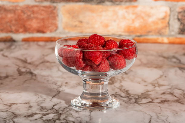 istock raspberries and cereals in a glass bowl 1341429424