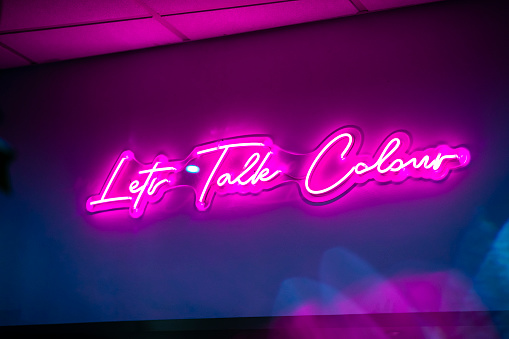 A pink neon light sign reading 
