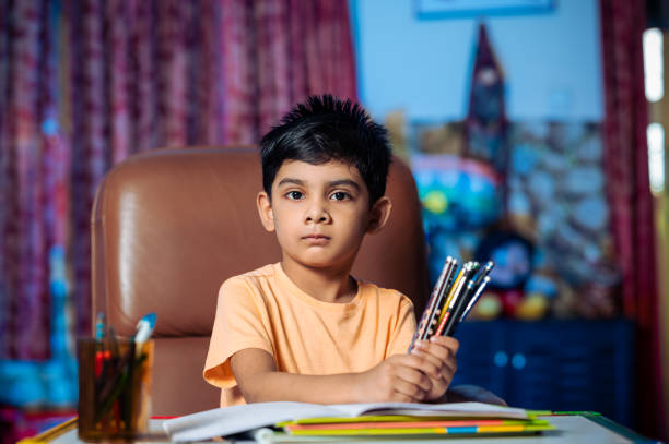 istock Portrait Of Boy Doing his school work or Homework 1341429842