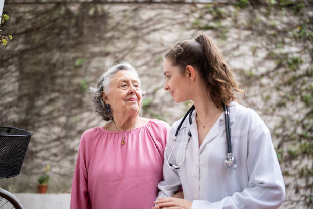 istock Nurse helping a senior patient walking at home 1341430679