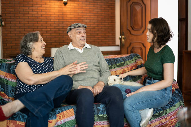 istock Grandparents and granddaughter talking at home 1341431069