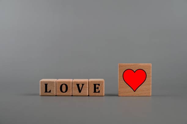 istock Love text with red heart shape icon on wooden cubes. 1341433656