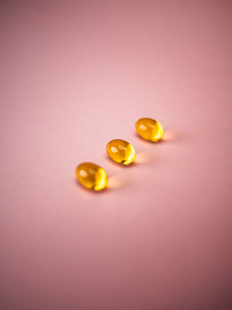 istock Capsules fish oil with selective focus isolate on pink background. Health care concept 1341433953