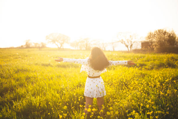 istock young woman in yellow field 1341434723