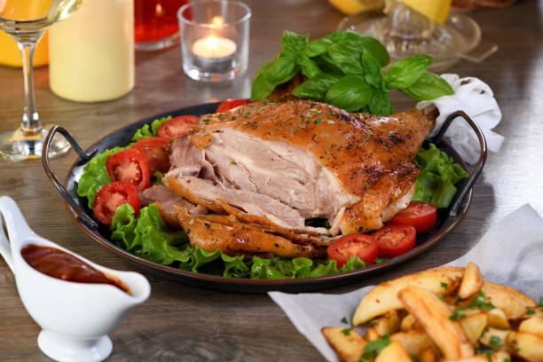 istock Sliced baked turkey drumstick on a vegetable tray at the Thanksgiving dinner table 1341436594