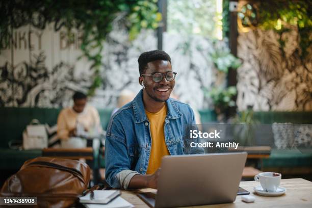 Young Man On A Video Call In A Cafe Stock Photo - Download Image Now - University Student, Laptop, Student