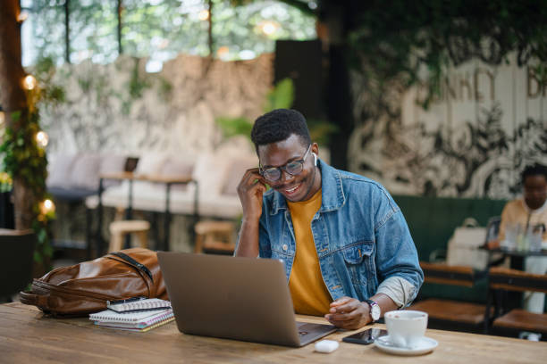 istock Young man on a video conference call in a cafe 1341439267
