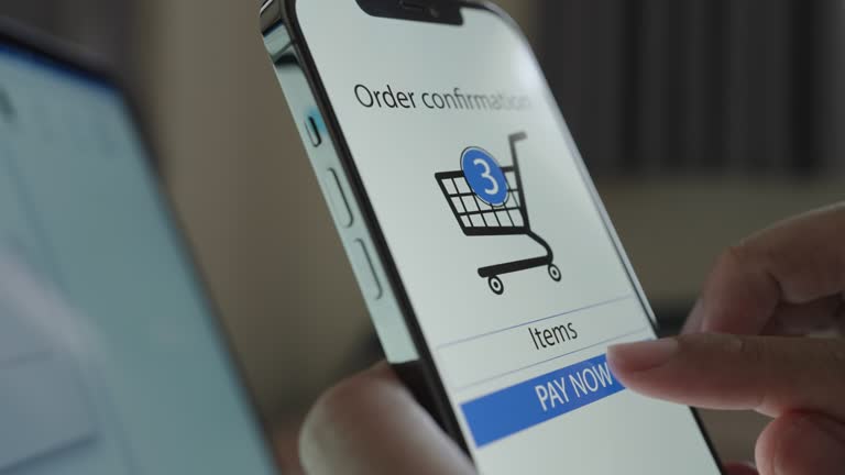 Close-up hand put Pay now Button on Device Screen for online shopping