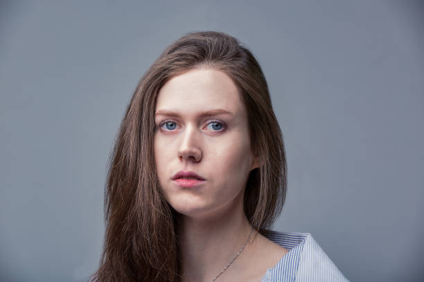istock beautiful girl with blue eyes posing over gray background 1341440001